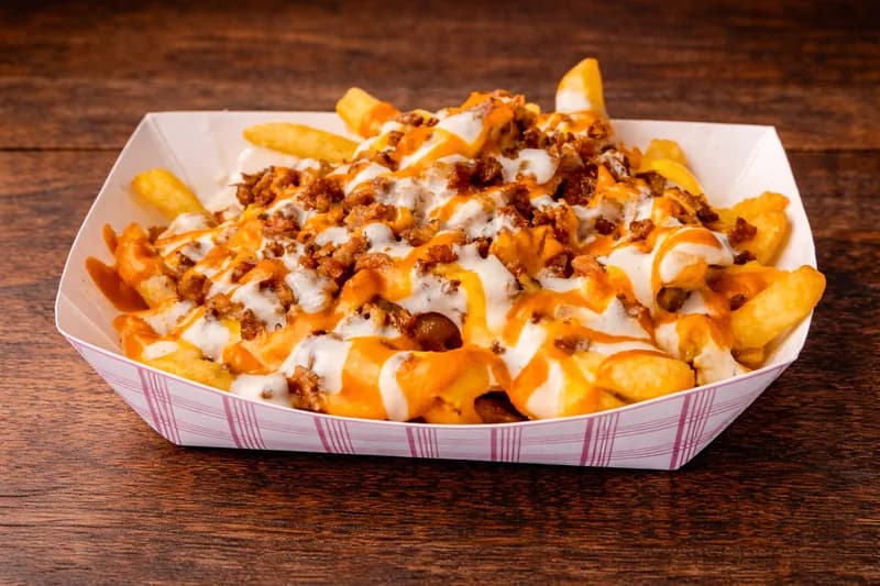 Loaded Fries - Crispy fries smothered in cheese sauce, ranch, and bacon crumbles.